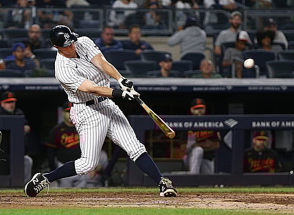 Sep 3, 2021; Bronx, New York, USA; New York Yankees second baseman DJ LeMahieu (26) drives in a run with a sacrifice fly against the Baltimore Orioles during the fifth inning at Yankee Stadium. Mandatory Credit: Andy Marlin-USA TODAY Sports
