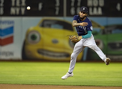 Sep 22, 2021; Oakland, California, USA; Seattle Mariners shortstop J.P. Crawford (3) throws out Oakland Athletics center fielder Starling Marte at first base during the fourth inning at RingCentral Coliseum. Mandatory Credit: D. Ross Cameron-USA TODAY Sports