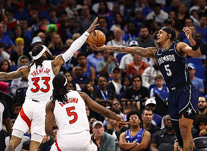 Nov 21, 2023; Orlando, Florida, USA; Toronto Raptors guard Gary Trent Jr. (33) and Orlando Magic forward Paolo Banchero (5) go after the basket during the second half at Amway Center. Mandatory Credit: Kim Klement Neitzel-USA TODAY Sports