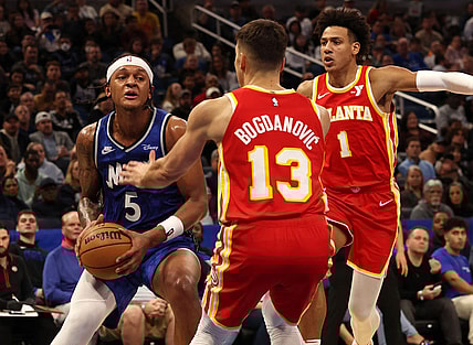 Jan 7, 2024; Orlando, Florida, USA; Orlando Magic forward Paolo Banchero (5) drives to the basket as Atlanta Hawks guard Bogdan Bogdanovic (13) defends during the second half at Kia Center. Mandatory Credit: Kim Klement Neitzel-USA TODAY Sports