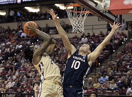 Feb 10, 2024; Tallahassee, Florida, USA; Virginia Cavaliers guard Taine Murray (10) defends the shot of Florida State Seminoles forward Jamir Watkins (2) during the second half at Donald L. Tucker Center. Mandatory Credit: Melina Myers-USA TODAY Sports