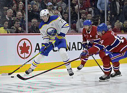 Feb 21, 2024; Montreal, Quebec, CAN; Buffalo Sabres forward Tage Thompson (72) plays the puck and Montreal Canadiens forward Nick Suzuki (14) defends during the second period at the Bell Centre. Mandatory Credit: Eric Bolte-USA TODAY Sports