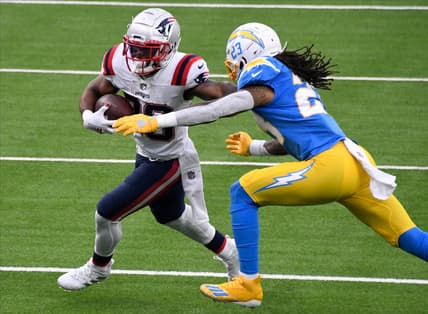 Dec 6, 2020; Inglewood, California, USA; New England Patriots running back James White (28) tries to break free from  Los Angeles Chargers free safety Nasir Adderley (24) during the second quarter at SoFi Stadium. Mandatory Credit: Robert Hanashiro-USA TODAY Sports