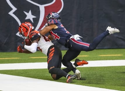 Dec 27, 2020; Houston, Texas, USA; Cincinnati Bengals wide receiver Tee Higgins (85) makes a reception for a touchdown against Houston Texans cornerback John Reid (34) during the third quarter at NRG Stadium. Mandatory Credit: Troy Taormina-USA TODAY Sports