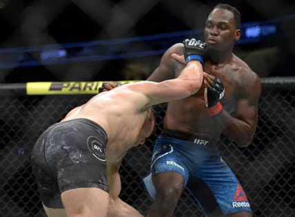 August 17, 2019; Anaheim, CA, USA; Ian Heinisch moves in with a hit  as Derek Brunson defends during UFC 241 at Honda Center. Mandatory Credit: Gary A. Vasquez-USA TODAY Sports