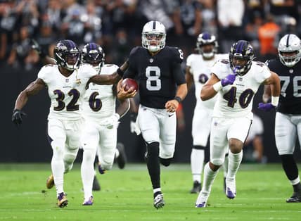 Sep 13, 2021; Paradise, Nevada, USA; Las Vegas Raiders quarterback Marcus Mariota (8) runs the ball ahead of Baltimore Ravens linebacker Patrick Queen (6) defensive back DeShon Elliott (32) and linebacker Malik Harrison (40) during the first half at Allegiant Stadium. Mandatory Credit: Mark J. Rebilas-USA TODAY Sports