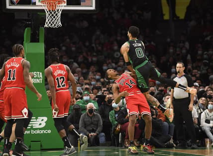 Jan 15, 2022; Boston, Massachusetts, USA; Boston Celtics forward Jayson Tatum (0) is called for an offensive foul on Chicago Bulls forward Malcolm Hill (14) during the second half at TD Garden. Mandatory Credit: Bob DeChiara-USA TODAY Sports