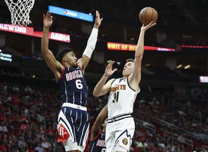 Jan 1, 2022; Houston, Texas, USA; Denver Nuggets forward Vlatko Cancar (31) shoots the ball as Houston Rockets forward Kenyon Martin Jr. (6) defends during the third quarter at Toyota Center. Mandatory Credit: Troy Taormina-USA TODAY Sports