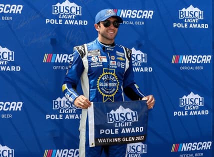 Aug 20, 2022; Watkins Glen, New York, USA; NASCAR Cup Series driver Chase Elliott stands with the pole award after winning the pole during practice and qualifying for the Go Bowling at The Glen at Watkins Glen International. Mandatory Credit: Matthew OHaren-USA TODAY Sports