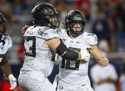 Oct 8, 2022; Tucson, Arizona, USA; Oregon Ducks quarterback Bo Nix (10) celebrates a touchdown with offensive lineman Ryan Walk (53) against the Arizona Wildcats at Arizona Stadium. Mandatory Credit: Mark J. Rebilas-USA TODAY Sports