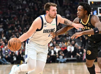 Nov 26, 2022; Toronto, Ontario, CAN;  Dallas Mavericks guard Luka Doncic (77) tries to dribble the ball past Toronto Raptors forward OG Anunoby (3) in the first half at Scotiabank Arena. Mandatory Credit: Dan Hamilton-USA TODAY Sports