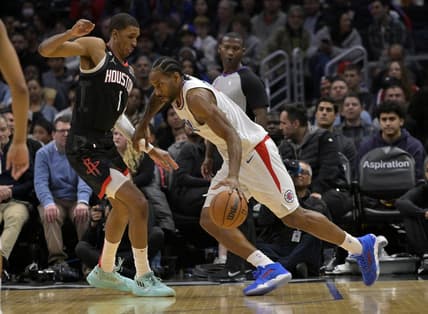Jan 15, 2023; Los Angeles, California, USA; Los Angeles Clippers forward Kawhi Leonard (2) drives past Houston Rockets forward Jabari Smith Jr. (1) in the first half at Crypto.com Arena. Mandatory Credit: Jayne Kamin-Oncea-USA TODAY Sports