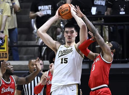 Feb 19, 2023; West Lafayette, Indiana, USA; Purdue Boilermakers center Zach Edey (15) keeps the ball away from Ohio State Buckeyes guard Eugene Brown III (3) during the first half at Mackey Arena. Mandatory Credit: Marc Lebryk-USA TODAY Sports