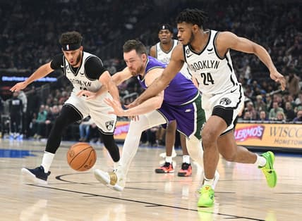 Mar 9, 2023; Milwaukee, Wisconsin, USA; Brooklyn Nets guards Seth Curry (30), left, and Cam Thomas (24) battle for the ball with Milwaukee Bucks guard Pat Connaughton (24) in the first half at Fiserv Forum. Mandatory Credit: Michael McLoone-USA TODAY Sports