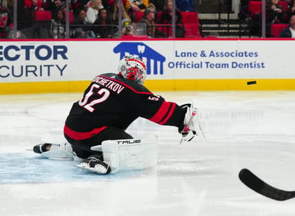 Feb 22, 2024; Raleigh, North Carolina, USA; Carolina Hurricanes goaltender Pyotr Kochetkov (52) makes a blocker save against the Florida Panthers during the second period at PNC Arena. Mandatory Credit: James Guillory-USA TODAY Sports