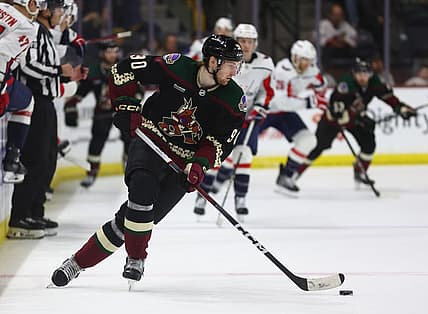 Dec 4, 2023; Tempe, Arizona, USA; Arizona Coyotes defenseman J.J. Moser (90) moves the puck against the Washington Capitals in the third period at Mullett Arena. Mandatory Credit: Mark J. Rebilas-USA TODAY Sports