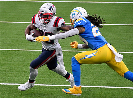 Dec 6, 2020; Inglewood, California, USA; New England Patriots running back James White (28) tries to break free from  Los Angeles Chargers free safety Nasir Adderley (24) during the second quarter at SoFi Stadium. Mandatory Credit: Robert Hanashiro-USA TODAY Sports