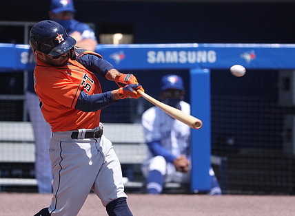 Jun 6, 2021; Buffalo, New York, USA;  Houston Astros second baseman Jose Altuve (27) hits a home run during the first inning against the Toronto Blue Jays at Sahlen Field. Mandatory Credit: Timothy T. Ludwig-USA TODAY Sports