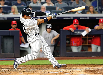 Jul 21, 2021; Bronx, New York, USA; New York Yankees shortstop Gleyber Torres (25) hits a solo home run against the Philadelphia Phillies during the fourth inning at Yankee Stadium. Mandatory Credit: Andy Marlin-USA TODAY Sports