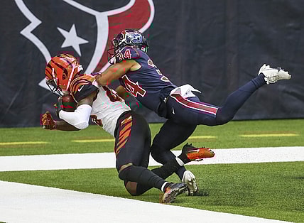 Dec 27, 2020; Houston, Texas, USA; Cincinnati Bengals wide receiver Tee Higgins (85) makes a reception for a touchdown against Houston Texans cornerback John Reid (34) during the third quarter at NRG Stadium. Mandatory Credit: Troy Taormina-USA TODAY Sports