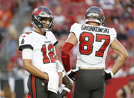 Aug 14, 2021; Tampa, Florida, USA;  Tampa Bay Buccaneers quarterback Tom Brady (12) and tight end Rob Gronkowski (87) looks on against the Cincinnati Bengals during the first quarter at Raymond James Stadium. Mandatory Credit: Kim Klement-USA TODAY Sports