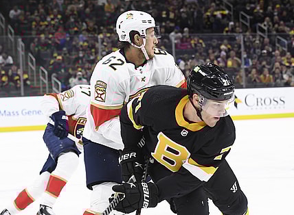 Oct 30, 2021; Boston, Massachusetts, USA;  Florida Panthers defenseman Brandon Montour (62) and Boston Bruins left wing Taylor Hall (71) battle during the first period at TD Garden. Mandatory Credit: Bob DeChiara-USA TODAY Sports