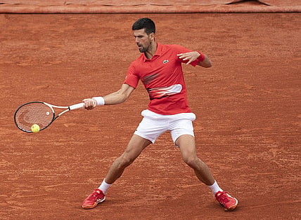 May 25, 2022; Paris, France; Novak Djokovic (SRB) returns a shot from Alex Molten (SVK)  during their match on day four of the French Open at Stade Roland-Garros. Mandatory Credit: Susan Mullane-USA TODAY Sports