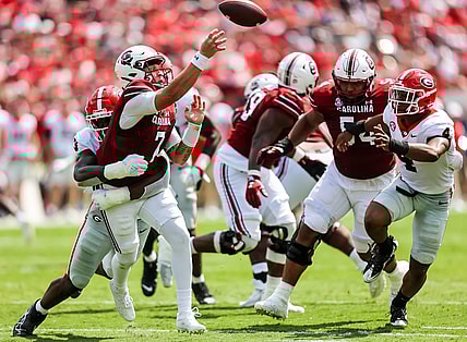 Sep 17, 2022; Columbia, South Carolina, USA; South Carolina Gamecocks quarterback Spencer Rattler (7) passes as he is hit by Georgia Bulldogs defensive lineman Mykel Williams (13) in the second quarter at Williams-Brice Stadium. Mandatory Credit: Jeff Blake-USA TODAY Sports