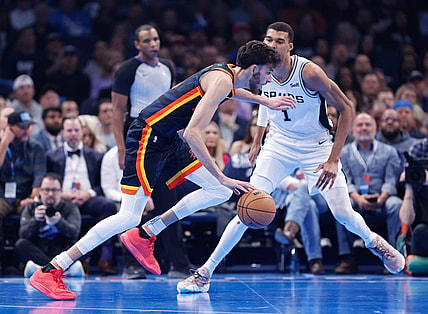 Nov 14, 2023; Oklahoma City, Oklahoma, USA; Oklahoma City Thunder forward Chet Holmgren (7) drives past San Antonio Spurs center Victor Wembanyama (1) during the second quarter at Paycom Center. Mandatory Credit: Alonzo Adams-USA TODAY Sports