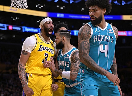 Dec 28, 2023; Los Angeles, California, USA;  Charlotte Hornets forward Cody Martin (11) gets in front of Los Angeles Lakers forward Anthony Davis (3) as he reacts after a dunk over Charlotte Hornets center Nick Richards (4) in the first half at Crypto.com Arena. Mandatory Credit: Jayne Kamin-Oncea-USA TODAY Sports
