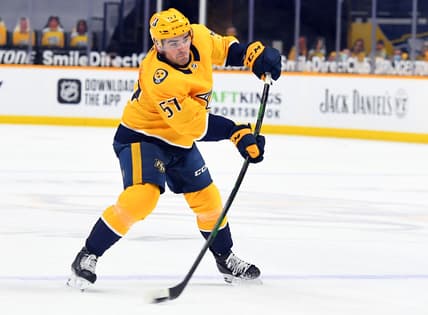 Feb 11, 2021; Nashville, Tennessee, USA; Nashville Predators defenseman Dante Fabbro (57) scores the game-winning goal late in the third period to beat the Detroit Red Wings at Bridgestone Arena. Mandatory Credit: Christopher Hanewinckel-USA TODAY Sports