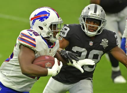 Oct 4, 2020; Paradise, Nevada, USA; Buffalo Bills running back Devin Singletary (26) looks to run past Las Vegas Raiders free safety Lamarcus Joyner (29) during the third quarter at Allegiant Stadium. Mandatory Credit: Stephen R. Sylvanie-USA TODAY Sports
