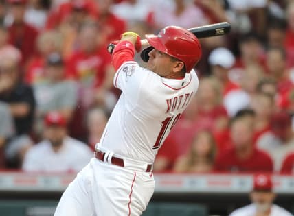 Aug 5, 2021; Cincinnati, Ohio, USA; Cincinnati Reds first baseman Joey Votto (19) hits a three-run home run against the Pittsburgh Pirates during the second inning at Great American Ball Park. Mandatory Credit: David Kohl-USA TODAY Sports