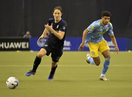 Mar 5, 2022; Montreal, Quebec, CAN; CF Montreal midfielder Lassi Lappalainen (21) and Philadelphia Union defender Nathan Harriel (26) chase the ball during the first half at Olympic Stadium. Mandatory Credit: Eric Bolte-USA TODAY Sports