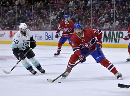 Mar 12, 2022; Montreal, Quebec, CAN; Montreal Canadiens defenseman Jeff Petry (26) takes a shot and Seattle Kraken forward Colin Blackwell (43) defends during the first period at the Bell Centre. Mandatory Credit: Eric Bolte-USA TODAY Sports