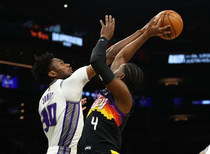 Apr 10, 2022; Phoenix, Arizona, USA; Phoenix Suns guard Aaron Holiday (4) has his shot blocked by Sacramento Kings center Damian Jones (30) during the first half at Footprint Center. Mandatory Credit: Mark J. Rebilas-USA TODAY Sports