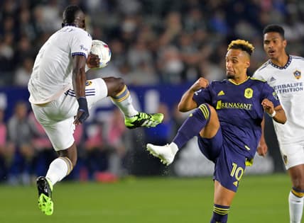 Apr 23, 2022; Carson, California, USA;  Los Angeles Galaxy defender Sega Coulibaly (4) and Nashville SC midfielder Hany Mukhtar (10) battle for the ball in the first half at Dignity Health Sports Park. Mandatory Credit: Jayne Kamin-Oncea-USA TODAY Sports