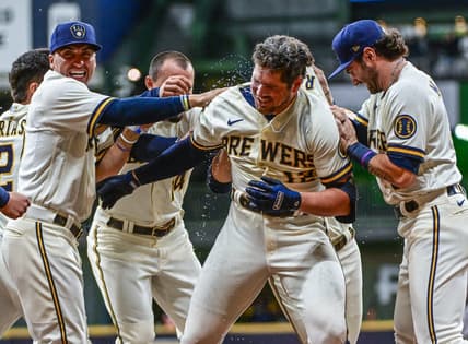 Oct 3, 2022; Milwaukee, Wisconsin, USA; Milwaukee Brewers right fielder Hunter Renfroe (12) celebrates after driving in the winning run in the tenth inning against the Arizona Diamondbacks at American Family Field. Mandatory Credit: Benny Sieu-USA TODAY Sports