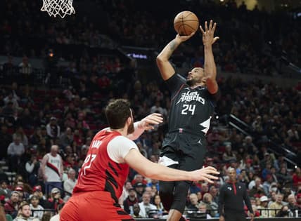 Nov 29, 2022; Portland, Oregon, USA;  LA Clippers forward Norman Powell (24) shoots a basket during the first half against Portland Trail Blazers center Jusuf Nurkic (27) at Moda Center. Mandatory Credit: Troy Wayrynen-USA TODAY Sports