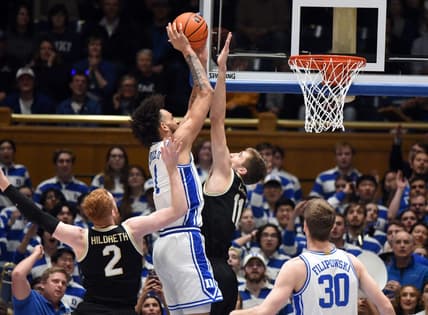 Jan 31, 2023; Durham, North Carolina, USA; Duke Blue Devils center Dereck Lively (1) shoots over Wake Forest Demon Deacons forward Andrew Carr (11) during the first half at Cameron Indoor Stadium. Mandatory Credit: Rob Kinnan-USA TODAY Sports