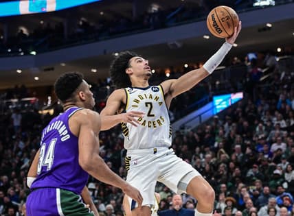 Mar 16, 2023; Milwaukee, Wisconsin, USA; Indiana Pacers guard Andrew Nembhard (2) takes a shot against Milwaukee Bucks forward Giannis Antetokounmpo (34) in the fourth quarter at Fiserv Forum. Mandatory Credit: Benny Sieu-USA TODAY Sports