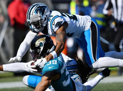 Jacksonville Jaguars wide receiver Jamal Agnew (39) gets tackled by Carolina Panthers cornerback Shaquill Griffin (20) and safety Vonn Bell (24) on a first down pass play to the 5-yard line late in the second quarter. Agnew was injured at the end of the play. The Jacksonville Jaguars hosted the Carolina Panthers at EverBank Stadium in Jacksonville, FL Sunday, December 31, 2023. The Jaguars went in at the half with a 9 to 0 lead. [Bob Self/Florida Times-Union]