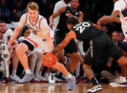 Mar 14, 2024; New York City, NY, USA;  Connecticut Huskies guard Cam Spencer (12) steals the ball from Xavier Musketeers guard Dayvion McKnight (20) during the first half at Madison Square Garden. Mandatory Credit: Robert Deutsch-USA TODAY Sports