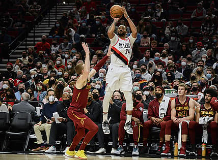 Jan 7, 2022; Portland, Oregon, USA;  Portland Trail Blazers forward Norman Powell (24) shoots a three point basket during the second half against Cleveland Cavaliers guard Dylan Windler (9) at Moda Center. The Cavaliers won 114-101. Mandatory Credit: Troy Wayrynen-USA TODAY Sports