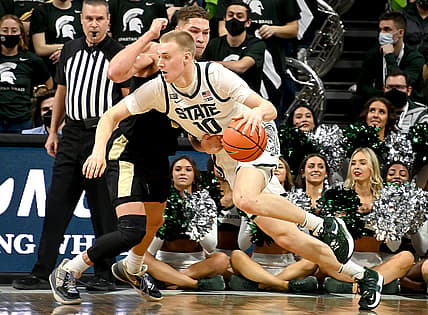 Feb 26, 2022; East Lansing, Michigan, USA;  Michigan State Spartans forward Joey Hauser (10) drives around Purdue Boilermakers forward Mason Gillis (0) in the first half at Jack Breslin Student Events Center. Mandatory Credit: Dale Young-USA TODAY Sports