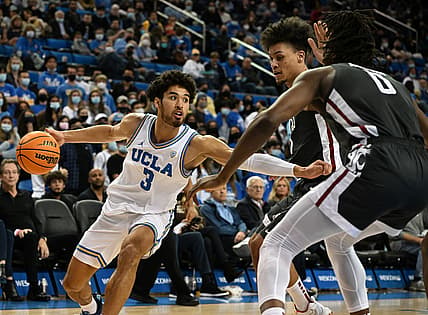 Feb 17, 2022; Los Angeles, California, USA;  UCLA Bruins guard Johnny Juzang (3) controls the ball while defended by Washington State Cougars forward DJ Rodman (11) and forward Efe Abogidi (0) in the second half of the game at Pauley Pavilion presented by Wescom. Mandatory Credit: Jayne Kamin-Oncea-USA TODAY Sports
