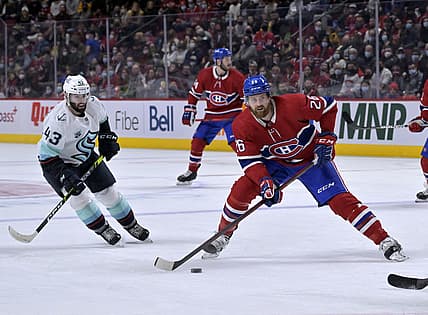 Mar 12, 2022; Montreal, Quebec, CAN; Montreal Canadiens defenseman Jeff Petry (26) takes a shot and Seattle Kraken forward Colin Blackwell (43) defends during the first period at the Bell Centre. Mandatory Credit: Eric Bolte-USA TODAY Sports