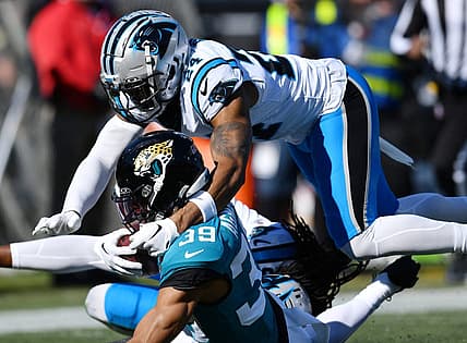 Jacksonville Jaguars wide receiver Jamal Agnew (39) gets tackled by Carolina Panthers cornerback Shaquill Griffin (20) and safety Vonn Bell (24) on a first down pass play to the 5-yard line late in the second quarter. Agnew was injured at the end of the play. The Jacksonville Jaguars hosted the Carolina Panthers at EverBank Stadium in Jacksonville, FL Sunday, December 31, 2023. The Jaguars went in at the half with a 9 to 0 lead. [Bob Self/Florida Times-Union]