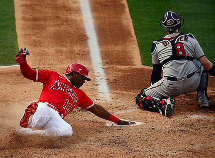 May 20, 2021; Anaheim, California, USA; Los Angeles Angels left fielder Justin Upton (10) scores a run ahead of Minnesota Twins catcher Mitch Garver (8) during the second inning at Angel Stadium. Mandatory Credit: Gary A. Vasquez-USA TODAY Sports