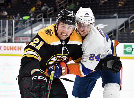 May 10, 2021; Boston, Massachusetts, USA;  Boston Bruins left wing Nick Ritchie (21) and New York Islanders defenseman Nick Leddy (2) battle for position during the second period at TD Garden. Mandatory Credit: Bob DeChiara-USA TODAY Sports
